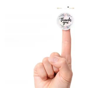Detail of 1.5 inch matte thank you stickers with pink floral design for wedding packaging