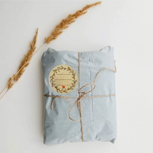 Macro detail of Kraft paper seal label with heart on blue wrapped gift package