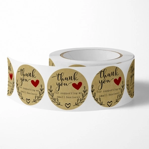 Kraft paper thank you stickers for small business packaging on a roll with heart icons