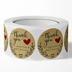 Roll of brown kraft thank you stickers for small business packaging on white background