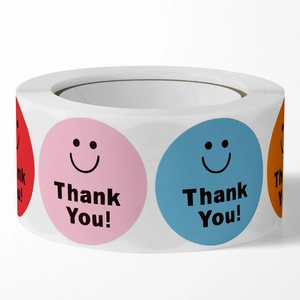 Roll of multi-colored smiley face thank you stickers for packaging and gift sealing
