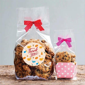Detail of clear gift bags with Thank You stickers and ribbons for handmade cookies