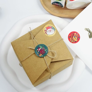 Cartoon Christmas gift labels on kraft box with Santa Claus and gingerbread man designs