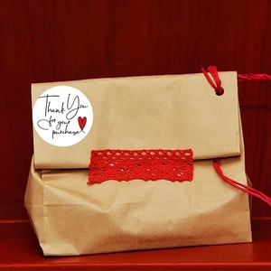 Brown kraft gift bag with white Thank You sticker, red lace trim and twine ribbon closure