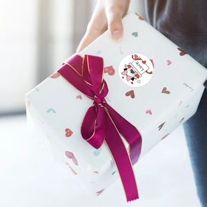 Cartoon dog sticker with Love text on gift box with magenta ribbon for decoration