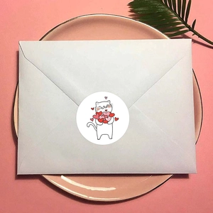 Cute white cat with red hearts sticker on a white envelope for decorative sealing