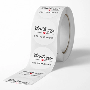 Roll of white round stickers with black Thank You for Your Order text and red heart