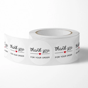 Roll of round white 'Thank You' stickers with red hearts for gift sealing and packaging