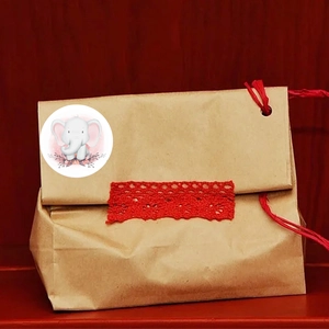 Brown kraft paper gift bag with red lace, twine, and a cute pink elephant sticker label