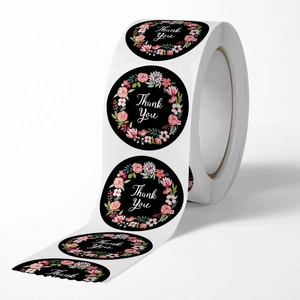 Roll of black floral Thank You stickers with elegant pink blossoms for gift sealing