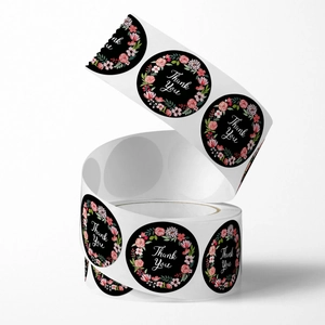 Floral Thank You stickers roll with black background and white script lettering