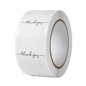 White round thank you stickers roll with black cursive text and small red heart accent