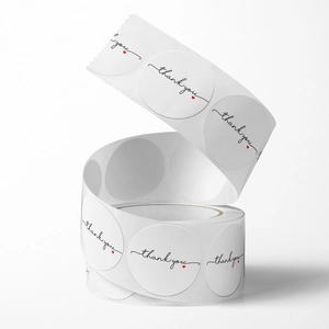 Roll of white circular Thank You stickers with black script and small red heart detail