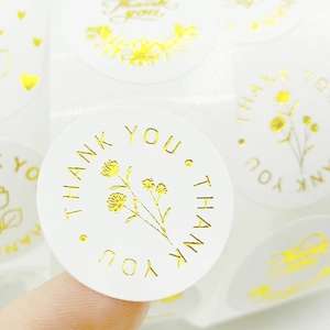 Round gold foil Thank You stickers with floral design for small business packaging