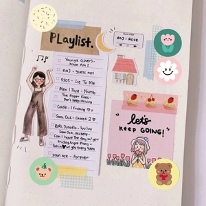 Detail of cute Korean-style stationery stickers and washi tape on a grid notebook page