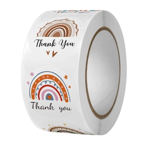 Close-up of rainbow Thank You stickers roll for DIY gift packaging and sealing