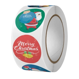 Detail of round Christmas gift label rolls featuring Santa Claus and Merry Christmas text