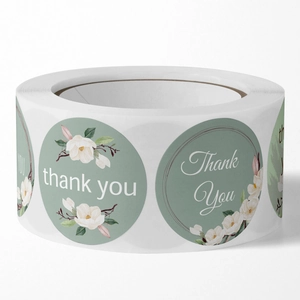 Roll of elegant sage green floral thank you stickers with white magnolia for gift sealing