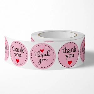 Pink round thank you stickers roll with red heart for wedding and gift packaging