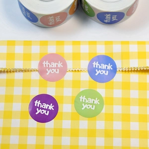 Pastel round Thank You stickers for gift packaging on yellow checkered bags