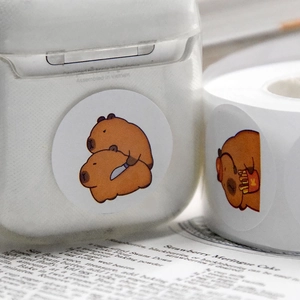 Cute cartoon capybara stickers on earphone case and a roll of decorative decals
