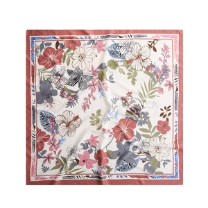 Detail of floral silk scarf showing tropical hibiscus prints and rolled hem edges