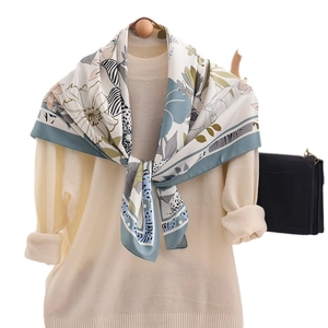 Floral and zebra print silk scarf in grey-blue paired with a cream knit sweater