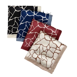 Silk-like square scarves with abstract giraffe print and geometric patterns in four colors