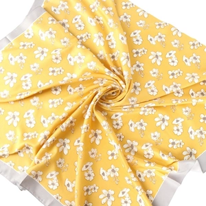 Elegant floral silk scarf in vibrant yellow with white blossoms and a grey border frame