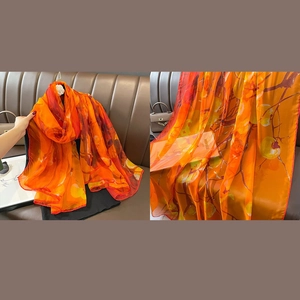 Elegant orange printed silk scarf with floral persimmon motifs for beach and vacation wear