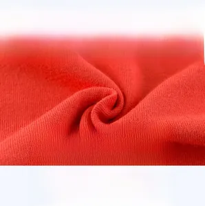 Macro detail of red knit cotton fabric showing soft and breathable texture for kids t-shirt