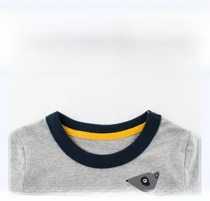 Close-up of boys' grey long sleeve t-shirt collar with blue ribbing and yellow inner tape