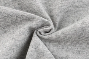 Close-up of soft heather grey knitted cotton fabric showing fine texture and elasticity
