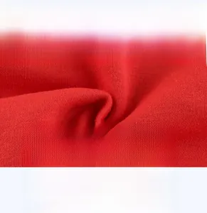 Close-up of red knitted children's sweatshirt fabric showing soft and breathable texture