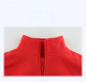Close-up of red fleece sweatshirt collar with zipper detail and neat stitching