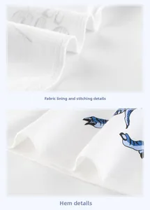 Detail of white cotton shirt showing neat double-stitching and blue dinosaur claw print