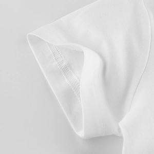 Detailed view of white cotton T-shirt sleeve stitching and durable seam craftsmanship