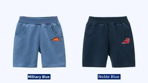 Detail view of cotton shorts with embroidered dinosaur motifs in army blue and royal blue