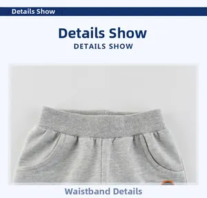 Detail of the elastic ribbed waistband and pockets on grey knitted shorts for boys
