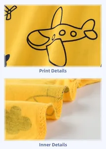 Détail du tricot en coton jaune avec imprimé avion et finitions des coutures de précision