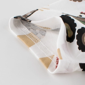 Close-up of white cotton children's T-shirt with cartoon car print and neat stitching