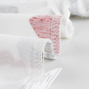 Kids white cotton T-shirt with red print showing detailed stitching and laundry labels