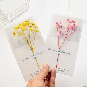 Minimalist handmade greeting cards with real yellow and pink dried flowers on white cardstock