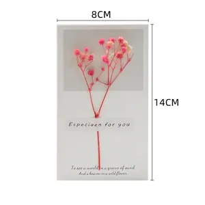 Detail of minimalist card with pink dried baby's breath flowers and elegant English text