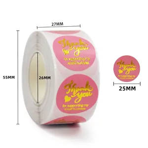 Detailed view of 25mm pink and gold thank you stickers in 500-label rolls for packaging