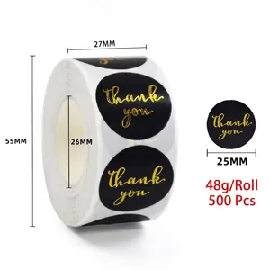 Detail view of 500 count 25mm black and gold foil thank you stickers in a roll