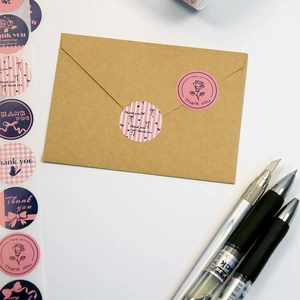 Pink floral Thank You stickers on brown envelope for elegant gift packaging and business mail