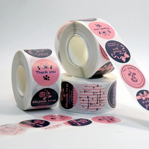 Detailed view of three rolls of Thank You floral bow-knot stickers for gift packaging