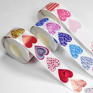 Roll of heart shaped thank you stickers with multiple artistic patterns for gift wrapping