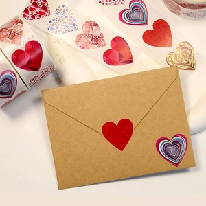 Close-up of assorted heart-shaped gift labels on a kraft envelope for wedding packaging